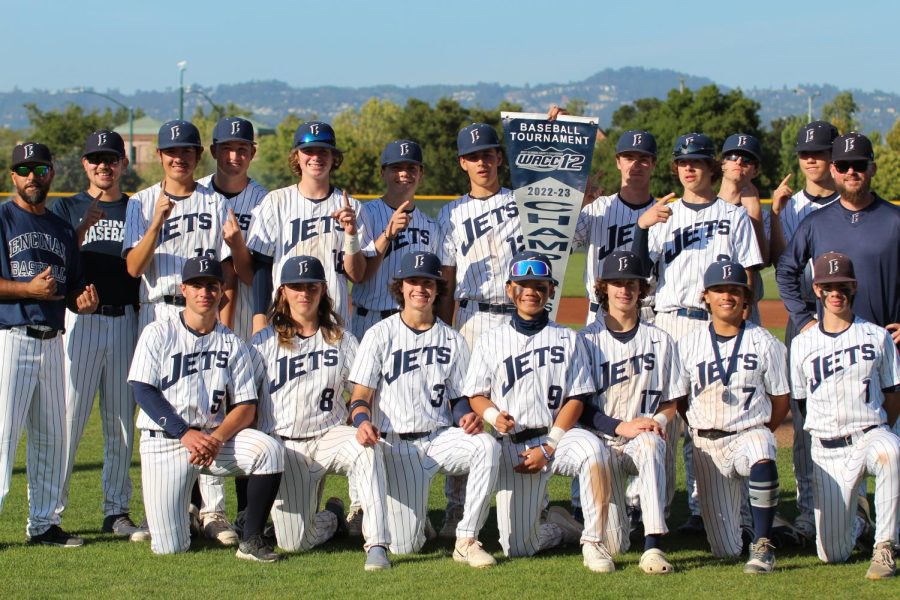 The Encinal Jets display their WACC Championship banner after defeating San Leandro 4-1.