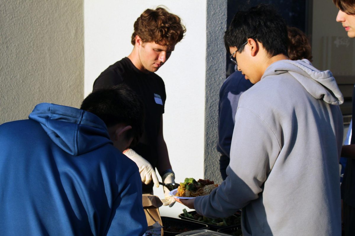 Senior Justice Petersen serves lunch to participants.