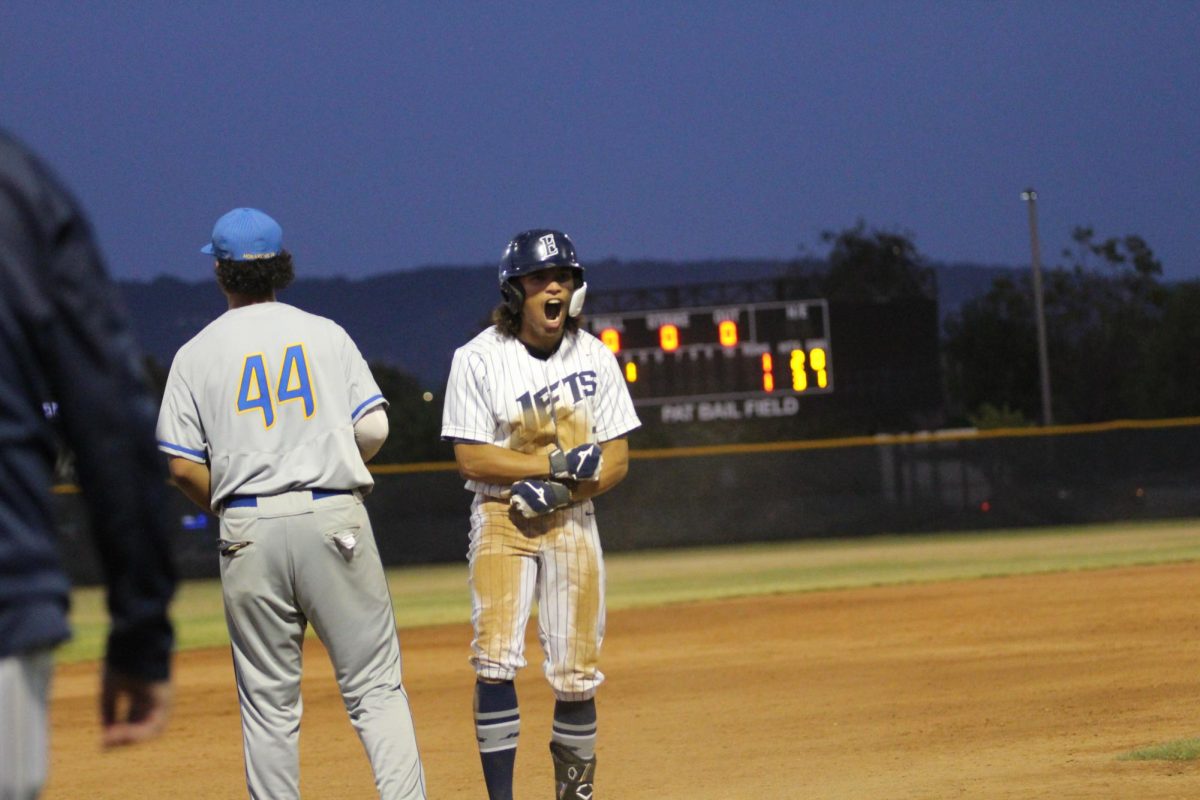 Junior Anthony Wilson celebrates after hitting a leadoff triple to start the bottom of the 4th innng.