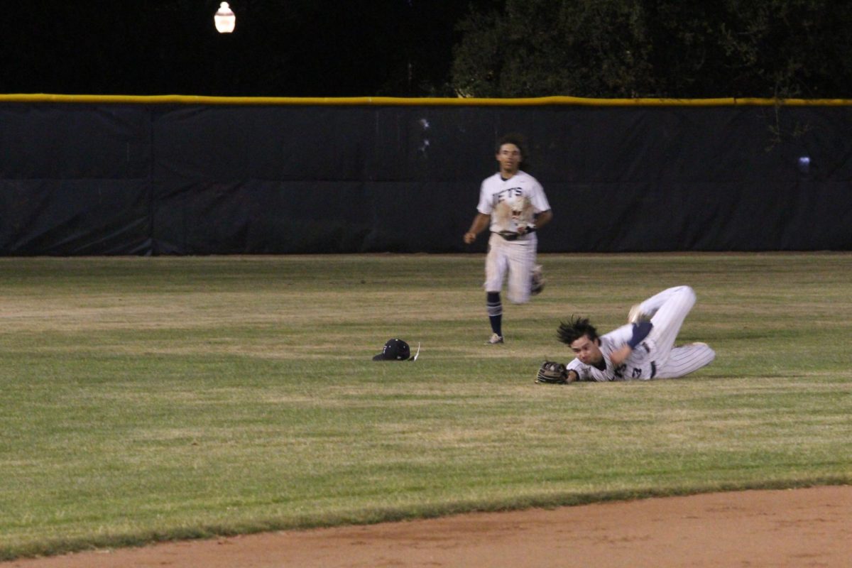 Senior Angus Olaes makes a diving catch in the 5th inning.