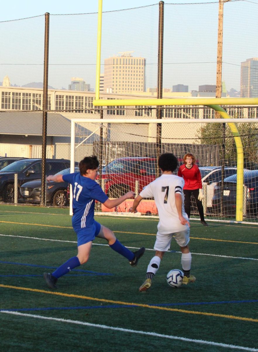 Jets' freshman defender Mason Daon lunges to stop Alameda High's winger (Mateus Penner) from getting a shot on goal.