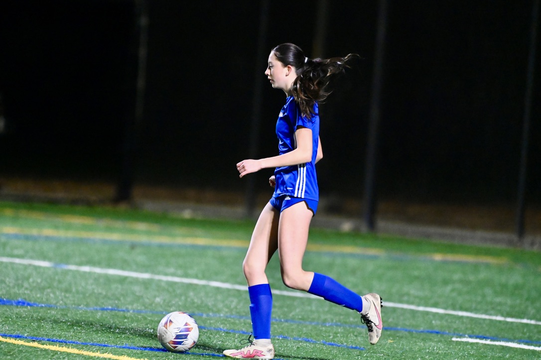 Varsity sophomore Amaya Zapeta, dribbles ball down field in awaited Island Derby on January 10, 2025.