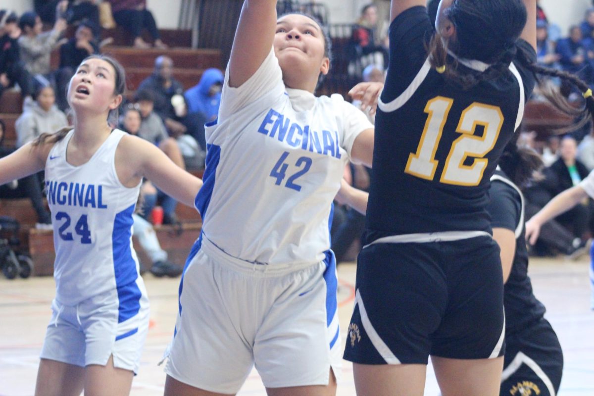 Center Olaniyi Mitchell (9th) rushes to the paints going up for the rebound at Encinal High School on January 11th.
