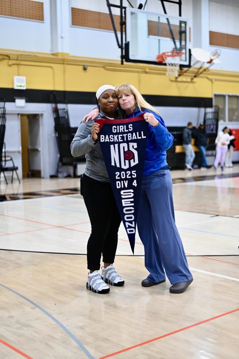 Encinal's principal Kirstin Snyder and Coach Juanita Lyons show off the Jets' Runner Up banner.