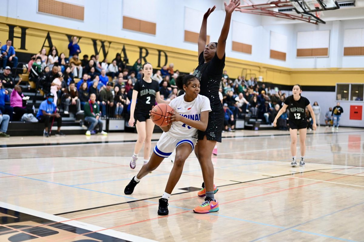 Junior Rayniesha Staine attempts to move the basketball past an extended Jayhawks’ defender.